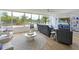 Stylish living room featuring a comfortable sofa, round rug, and scenic views through large windows at 100 Sands Point Rd # 225, Longboat Key, FL 34228