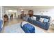Open-concept living room, dining area, and kitchen featuring stylish furnishings and ample natural light at 100 Sands Point Rd # 225, Longboat Key, FL 34228