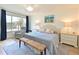 Bright main bedroom featuring a large window, cozy seating, and tasteful decor at 100 Sands Point Rd # 225, Longboat Key, FL 34228