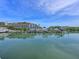Picturesque marina view with boats docked in calm water, reflecting the blue sky and nearby condo buildings at 100 Sands Point Rd # 225, Longboat Key, FL 34228