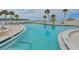 Community pool featuring gulf views and lounge seating at 100 Sands Point Rd # 225, Longboat Key, FL 34228