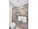 Tiled shower with glass doors, shower head, and a built-in shelf for soaps and other bath items at 1113 Lake House Cir # C110, Sarasota, FL 34242