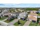 Expansive aerial view of neighborhood featuring many homes, lush greenery, and tranquil lake at 12130 Seabrook Ave, Bradenton, FL 34211