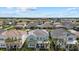 Beautiful aerial view of a lovely neighborhood featuring various homes with palm trees and blue skies at 12130 Seabrook Ave, Bradenton, FL 34211