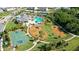 Aerial view of a community playground and pool area with tennis and basketball courts at 12130 Seabrook Ave, Bradenton, FL 34211