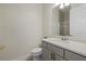 Stylish bathroom with a gray vanity, marble countertop, gold hardware, and a glass-enclosed shower at 12130 Seabrook Ave, Bradenton, FL 34211