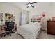 Bedroom featuring a comfortable bed, desk, and a decorated bookshelf for a personalized touch at 12130 Seabrook Ave, Bradenton, FL 34211