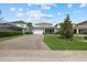 Well-maintained home featuring a manicured lawn, a two-car garage, and a screened-in porch at 12130 Seabrook Ave, Bradenton, FL 34211
