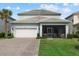 Charming home with a well-manicured lawn, a two-car garage, and a welcoming screened porch at 12130 Seabrook Ave, Bradenton, FL 34211
