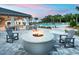 Community area featuring a cozy fire pit with ample seating and a view of the swimming pool at 12130 Seabrook Ave, Bradenton, FL 34211