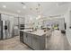 Modern kitchen with stainless steel appliances, a center island, and an open layout, perfect for entertaining at 12130 Seabrook Ave, Bradenton, FL 34211