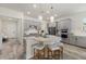 A modern kitchen featuring gray cabinets, stainless steel appliances, and a unique curved island with seating at 12130 Seabrook Ave, Bradenton, FL 34211