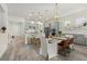 A spacious kitchen and dining area featuring gray cabinets, stainless steel appliances, and an island with seating at 12130 Seabrook Ave, Bradenton, FL 34211