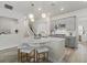 A contemporary kitchen with gray cabinets, stainless steel appliances, and a unique curved island with seating at 12130 Seabrook Ave, Bradenton, FL 34211