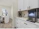 A clean, bright kitchen featuring white cabinets with bronze hardware and modern appliances plus ice maker at 12130 Seabrook Ave, Bradenton, FL 34211