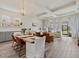 Open-concept living space featuring a dining table, comfortable seating, and abundant natural light for seamless living at 12130 Seabrook Ave, Bradenton, FL 34211