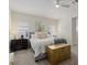 Inviting main bedroom with neutral tones, a comfortable bed, chest, and lots of natural light at 12130 Seabrook Ave, Bradenton, FL 34211