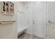 Welcoming mudroom with white paneling, wood-look tile, and a convenient built-in bench at 12130 Seabrook Ave, Bradenton, FL 34211