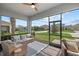 Screened porch with comfortable wicker seating, offering views of the manicured front yard at 12130 Seabrook Ave, Bradenton, FL 34211