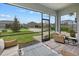 Inviting screened porch with cozy seating, offering a clear view of the well-maintained landscape at 12130 Seabrook Ave, Bradenton, FL 34211
