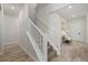 A stairway featuring white railing and carpeted steps leading to the upper level of the home at 12130 Seabrook Ave, Bradenton, FL 34211
