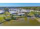 Overhead view showcasing a vibrant community nestled around a scenic lake, offering peaceful waterfront living at 1224 41St Avenue E Dr, Ellenton, FL 34222