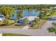 Lovely aerial view of home with mature palms and serene lake views at 1224 41St Avenue E Dr, Ellenton, FL 34222