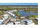 Beautiful aerial view of a tranquil community with a central lake surrounded by lush greenery and cozy homes at 1224 41St Avenue E Dr, Ellenton, FL 34222