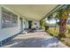 Spacious carport with golf cart, offering convenient parking and protection from the elements, surrounded by landscaping at 1224 41St Avenue E Dr, Ellenton, FL 34222