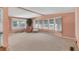 Spacious living room with multiple windows, neutral carpet, and comfortable furniture at 1224 41St Avenue E Dr, Ellenton, FL 34222