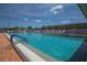 Beautiful community pool with brick deck, bright blue water, and lounge chairs at 1224 41St Avenue E Dr, Ellenton, FL 34222