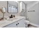 Bathroom featuring a large mirror, white cabinets, marble countertop, and matte black hardware at 1270 Gulf Blvd # 1503, Clearwater Beach, FL 33767