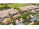 Aerial view of community homes with tile roofs next to the manicured fairways of the golf course at 1311 Triano Cir # 1311, Venice, FL 34292