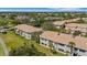 Aerial view showcasing tile roof and lush landscaping of the condos at 1311 Triano Cir # 1311, Venice, FL 34292