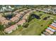 Aerial view of community homes alongside ponds and lush green golf course fairways at 1311 Triano Cir # 1311, Venice, FL 34292