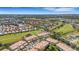 Expansive aerial view of the community's tiled roofs, pond, and golf course fairways at 1311 Triano Cir # 1311, Venice, FL 34292