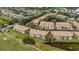 Aerial view of community with tile roofs, ponds, and meticulously maintained golf course fairways at 1311 Triano Cir # 1311, Venice, FL 34292