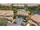 An aerial view of the community clubhouse, pool, and parking area surrounded by lush landscaping at 1311 Triano Cir # 1311, Venice, FL 34292
