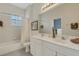 Bright bathroom featuring double sinks, tub with shower, window, and neutral finishes at 1311 Triano Cir # 1311, Venice, FL 34292