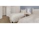 Bedroom featuring two twin beds with white linens and blue accent wall at 1311 Triano Cir # 1311, Venice, FL 34292