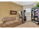 Bedroom featuring a comfortable sofa, full length mirror and custom shelving at 1311 Triano Cir # 1311, Venice, FL 34292