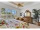 Comfortable bedroom with a large window, dresser and plant at 1311 Triano Cir # 1311, Venice, FL 34292