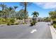 A community entrance sign surrounded by landscaping and an arrow pointing the way at 1311 Triano Cir # 1311, Venice, FL 34292