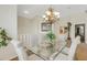 Elegant dining area with a glass-top table and seating for six, near the living room at 1311 Triano Cir # 1311, Venice, FL 34292