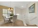 Bright dining room with chandelier and views from stairway landing at 1311 Triano Cir # 1311, Venice, FL 34292
