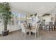Open dining room offers a glass-top table, elegant chairs, and a view of the kitchen area at 1311 Triano Cir # 1311, Venice, FL 34292