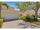 A view of the home's exterior with brick driveway and lush landscaping at 1311 Triano Cir # 1311, Venice, FL 34292