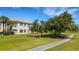 Exterior view showcasing community residences alongside the meticulously maintained golf course and walking path at 1311 Triano Cir # 1311, Venice, FL 34292