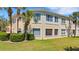 Inviting two-story condo with well-maintained landscaping, lush lawn and beautiful palm trees at 1311 Triano Cir # 1311, Venice, FL 34292