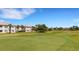 Picturesque view of community homes and a well-manicured golf course on a clear day at 1311 Triano Cir # 1311, Venice, FL 34292